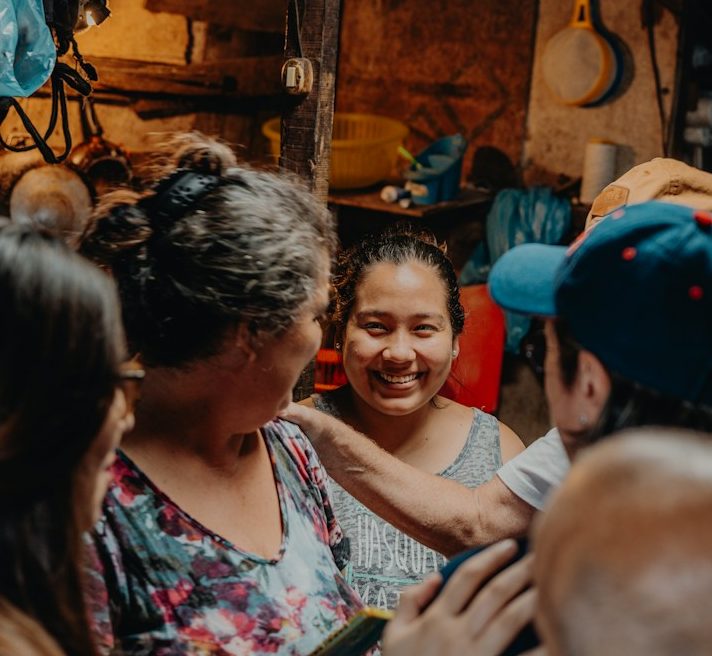 a group of people standing around each other
